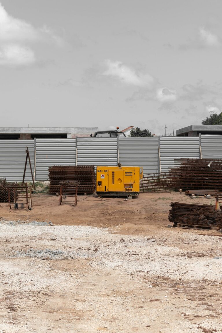 A person checking a portable home generator in a backyard before a storm.